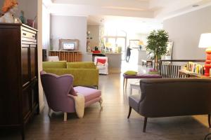 a living room with couches and chairs at Hotel Tuscania Panoramico in Tuscania