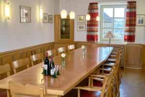 a large wooden table with bottles of wine on it at Ev.Familienferien-und Bildungsstätte Ebernburg in Bad Münster am Stein-Ebernburg +34 photos