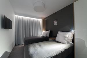 Postel nebo postele na pokoji v ubytování Apart-Hotel VIVI RESIDENCE & SPA