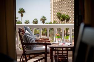 a balcony with a table and chairs and a view of a building at Sea View Apartment in Center of Las Americas in Playa de las Americas