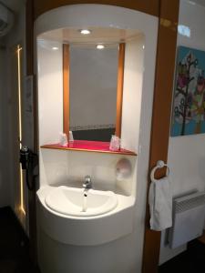 a bathroom with a sink and a mirror at Quick Palace St Jean De Vedas - A709 in Saint-Jean-de-Védas