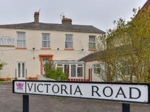 a sign in front of a victoria road house at The Warren Guest House in Carlisle