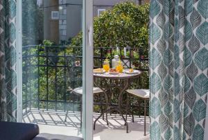 a table on a balcony with drinks on it at Apartments CenterLink in Split