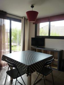 a dining room with a table and two chairs at Studio Clos de Charance in Gap