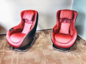 a row of red and black chairs with two red seats at HOTEL UNIZO Osaka Umeda in Osaka