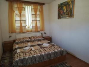 Postel nebo postele na pokoji v ubytování Apartment and Rooms Aračić