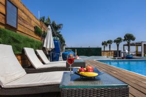 a glass of wine on a table next to a pool at Shakun Hotels And Resorts in Jaipur