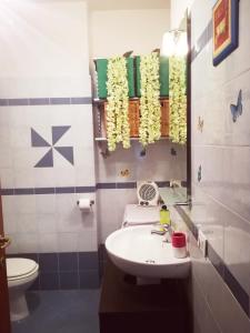 a bathroom with a sink and a toilet and a mirror at La Terrazza Di Seiano in Vico Equense