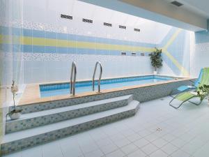 a swimming pool with two faucets in a room at Hotel Podhrad in Hluboká nad Vltavou