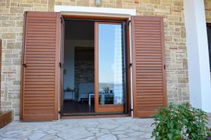 a sliding glass door with a view of the ocean at Marvelous Sea View Eco Apt in Ammouliani