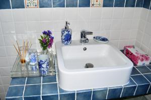 a white sink on a blue tiled counter at Marvelous Sea View Eco Apt in Ammouliani