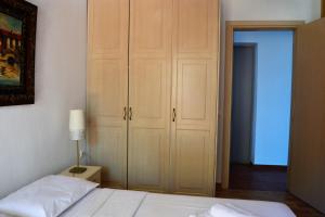 a bedroom with a bed and a large closet at Marvelous Sea View Eco Apt in Ammouliani