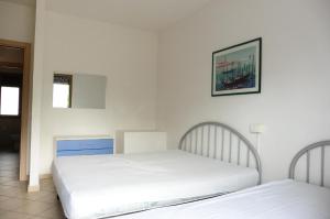 A bed or beds in a room at Appartamento Sabrina