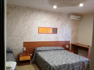 a small bedroom with a bed at Anthea Dell' Etna in Santa Venerina
