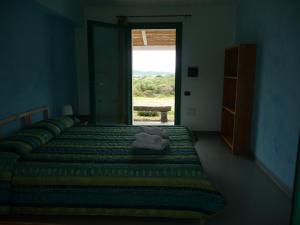 A bed or beds in a room at Agriturismo La Tana di Lu Maccioni