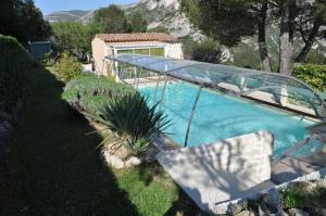 a swimming pool with a glass bridge over it at Lou Pin dou Papet in Roquevaire