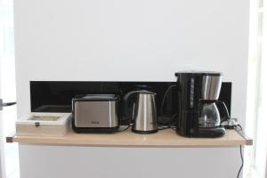 a shelf with various appliances sitting on it at Gîte les 3 tours 1e étage in Carcassonne