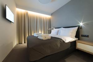 Postel nebo postele na pokoji v ubytování Apart-Hotel VIVI RESIDENCE & SPA