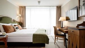 Postel nebo postele na pokoji v ubytování Bachleda Hotel Kasprowy