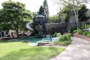 a playground with a slide in a yard at Chic East Sydney Pad in Sydney