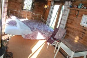 ein Schlafzimmer mit einem Bett in einer Holzhütte in der Unterkunft Off the Rails in Oswestry
