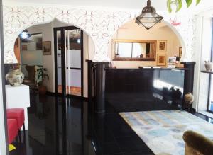 a living room with a black floor and a mirror at PLAYA Santa Baia in Vigo