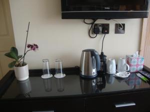 a counter top with a coffee maker and glasses on it at Canal View Bed And Breakfast in Lincoln