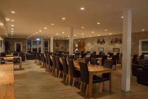 a dining room with a table and chairs at Vogur Country Lodge in Vogur