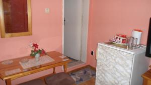 a small room with a table and a small refrigerator at Sadala Guest House in Nesebar