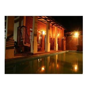 an empty swimming pool in a building at night at Plantation Retreat in Matale