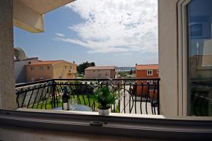 a view from a window of a balcony with a bottle of wine at Apartment Ivan in Kastel Sucurac