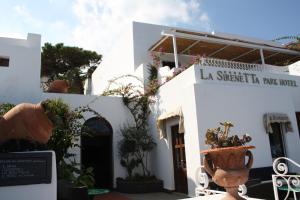 a white building with a sign that reads la strica la rave relied at La Sirenetta Park Hotel in Stromboli