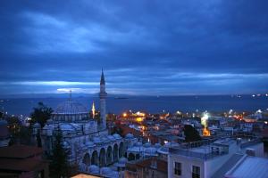 a view of a city at night with a mosque at Divas Hotel in Istanbul