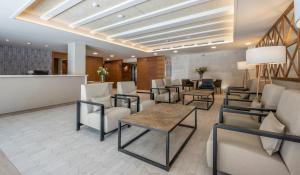 a waiting room at a hospital with chairs and tables at Rosamar Es Blau 4*s - Adults Only in Lloret de Mar