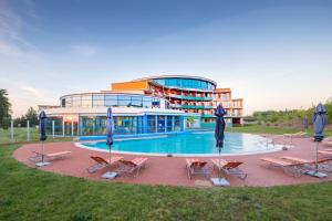 a large building with a swimming pool in front of it at Kurzentrum Waren (Müritz) in Waren