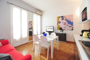 a living room with a white table and a red couch at Suite Halevy 5 stars Holiday House in Nice