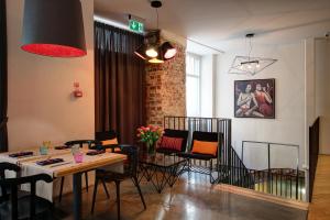 a living room with a table and chairs at Hestia Hotel Draugi in Rīga