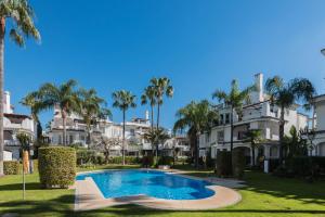 a villa with a swimming pool and palm trees at Bello Naranjo, Puerto Banus Los naranjos de Marbella in Marbella