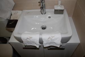 a bathroom sink with two towels on it at Apartman Bombon in Selce +28 photos