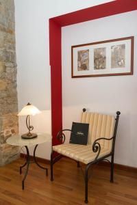 a room with a chair and a table with a laptop at Residence Theresia- Tailor Made Stay in Trieste