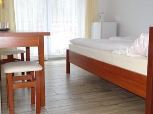 ミエンジズドロイェにあるWilla Hortensjaのベッドルーム1室(ベッド1台、テーブル、椅子付)