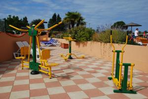 a group of exercise equipment on a patio at Camping Le Puits Rochais in Les Sables-dʼOlonne