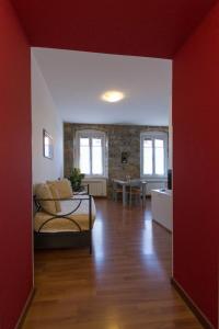 a living room with a bed and a dining room at Residence Theresia- Tailor Made Stay in Trieste