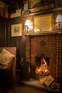 a living room with a fireplace and a fire place at Queens Head Inn & Restaurant in Hawkshead