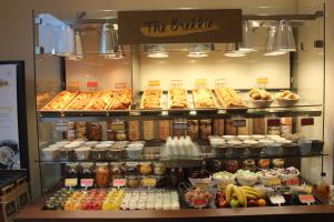 a display case in a store filled with lots of food at Point A Hotel London Shoreditch in London