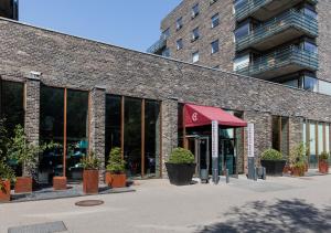 a brick building with plants in front of it at Charlottehaven in Copenhagen