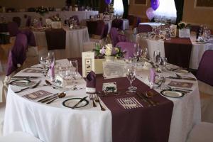 a table set up for a wedding with white tables and purple chairs at Langport Arms Hotel in Langport