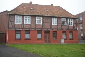 a red brick house with a brown roof at Fachwerkhaus in der Altstadt in Lüneburg