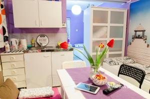 a kitchen with a table with a vase of flowers on it at Apartments Kamenecki in Krapina
