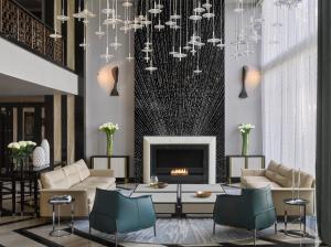 a living room with a fireplace and a chandelier at InterContinental Sofia, an IHG Hotel in Sofia